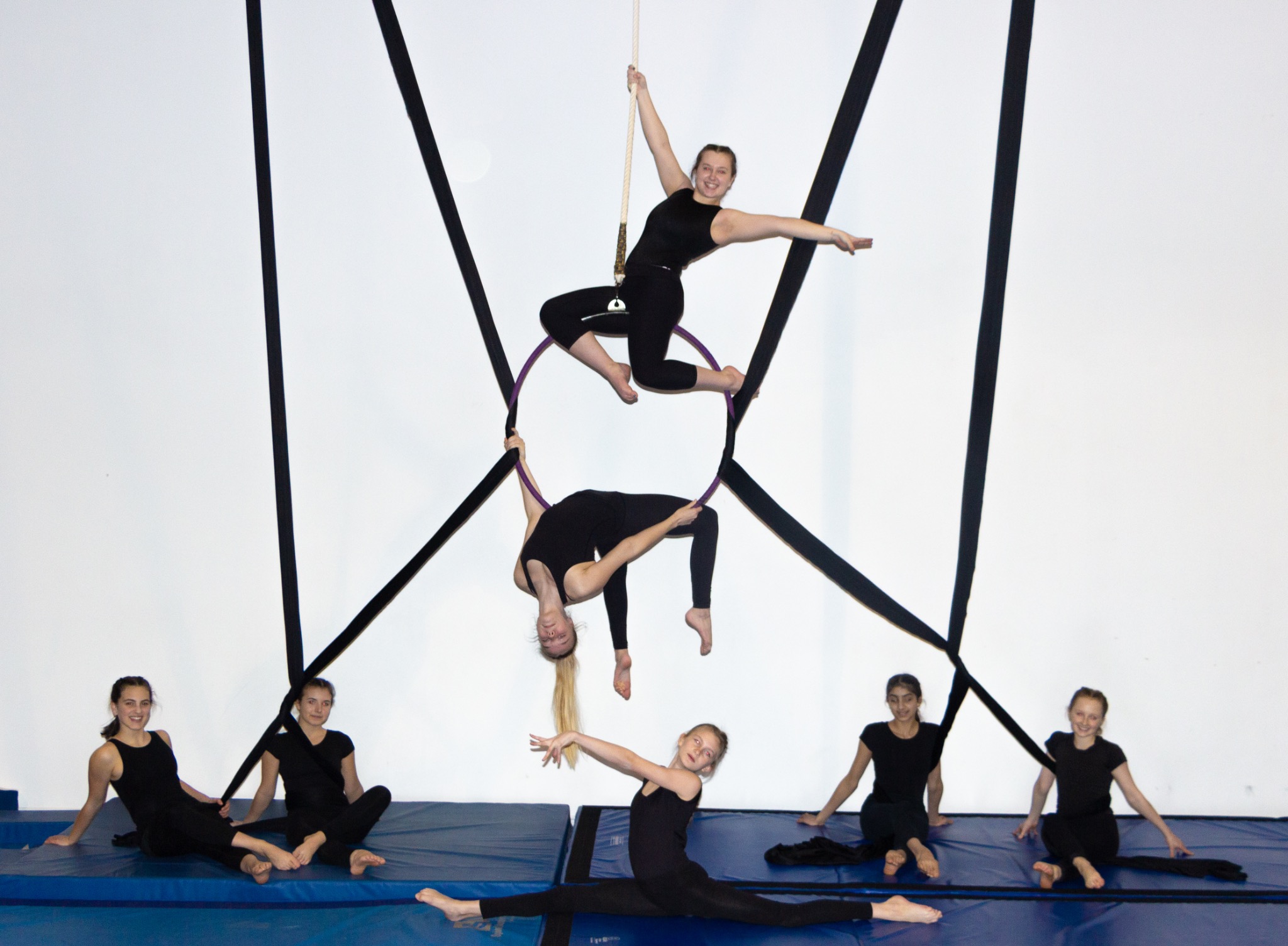 A group of Prestige participants demonstrating aerial hoop and floor skills